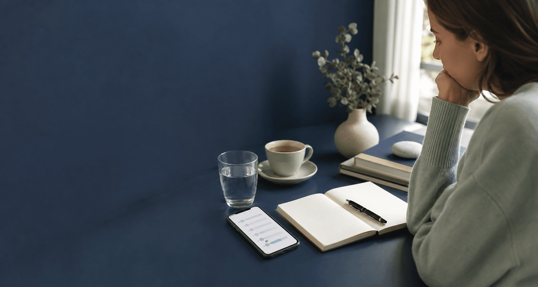 Phone and journal used to track possible migraine triggers